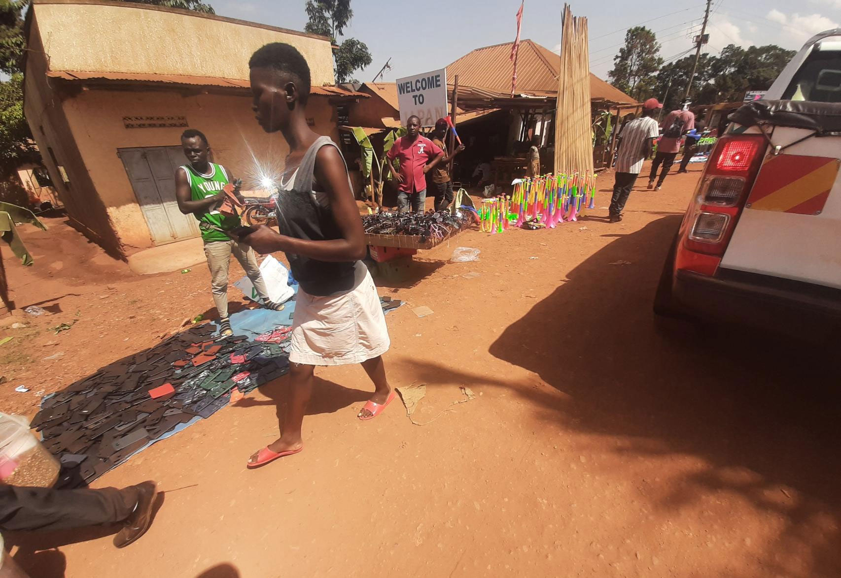 People selling vuvuzela's on the road to kitende